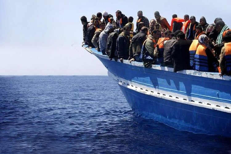 Barcone carico di migranti nel Mar Mediterraneo, simbolo della crisi migratoria verso l'Europa.