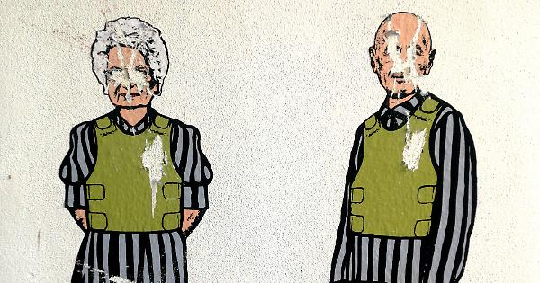 Vignetta satirica raffigurante due sopravvissuti all'Olocausto con divise da campo di concentramento e giubbotti antiproiettile, con il volto imbrattato.