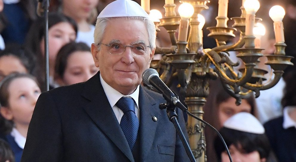 Sergio Mattarella durante una cerimonia nella comunità ebraica, con menorah e bambini sullo sfondo