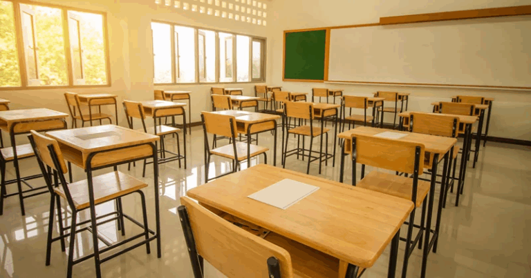 Aula scolastica vuota con banchi e sedie ordinati
