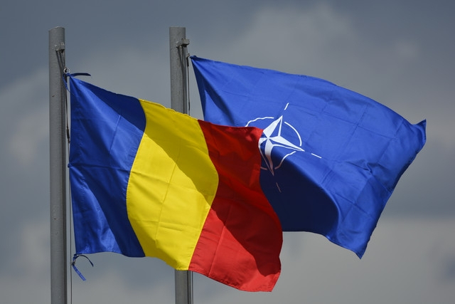 Bandiera rumena accanto a quella della NATO: simbolo del groviglio rumeno